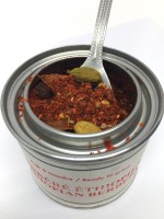 Photo of an open spice tin from Epice de Cru with whole spices visible.