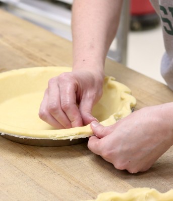 Crimping the buttery pie crust by hand for Zingerman's pies.