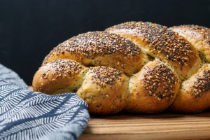 Side photo of a braided seeded Moroccan challah bread